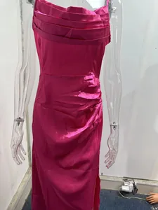 Detailed view of a vibrant fuchsia ruched satin evening dress with side slit detail