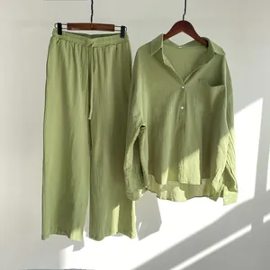 Detailed shot of a green linen two-piece set featuring a long-sleeved shirt and pants