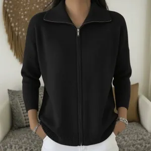Close-up of a stylish black zip-up knitted cardigan with a ribbed collar and cuffs