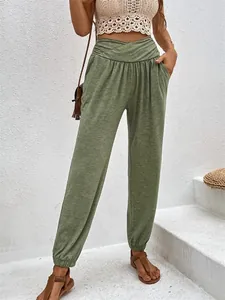 Casual high-waisted green joggers for women with side pockets and elastic cuffs