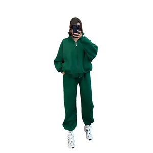 Two-piece dark green fleece tracksuit with zip-up hoodie and matching joggers