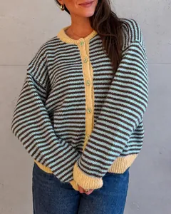 Detail of a cozy striped knit cardigan with yellow ribbed cuffs and neckline
