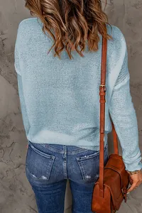 Detailed back view of a light blue long-sleeved knit sweater with textured weave