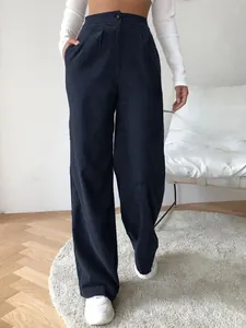 Close-up of navy blue corduroy wide-leg pants showing texture and high-waist fit
