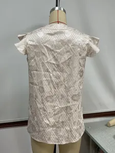 Detailed back view of a satin floral jacquard blouse with delicate flutter sleeves on mannequin