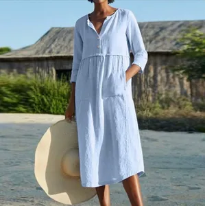 Casual light blue cotton linen dress with buttons and pockets shown on a model.