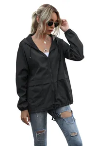 Close-up detail view of lightweight black hooded outdoor rain jacket for women hiking