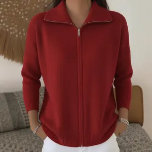 Detailed view of a dark red ribbed knit cardigan with silver zipper and lapel collar
