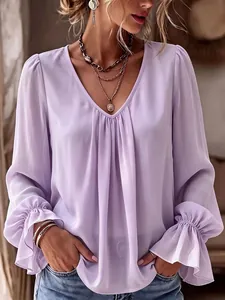 Detailed view of lavender V-neck pleated blouse with elegant ruffled cuffs and loose fit