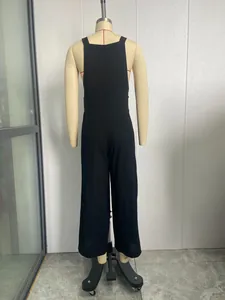 Detailed back view of a minimalist black solid casual wide-leg jumpsuit on mannequin