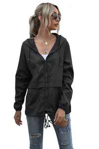Model wearing a black lightweight hooded windbreaker with front zipper detail