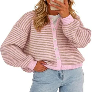 Close-up of pink striped knit cardigan with round neck and white button closures