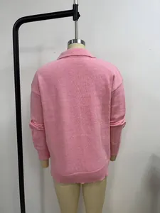 Pink knitted cardigan sweater back view detail, soft fabric texture, solid color casual style.