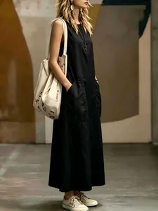 Elegant black sleeveless maxi dress with pockets for a minimalist summer fashion look