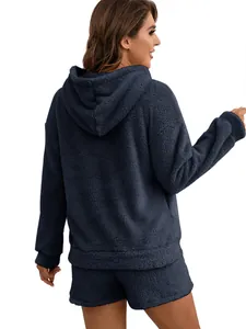 Back view of cozy dark blue plush hooded sweatshirt and matching shorts on a model
