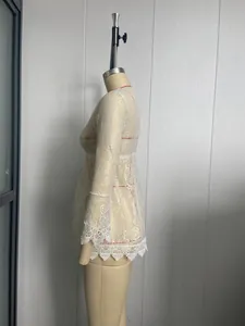 Detailed side view of white floral lace beach cover-up on mannequin showing sleeve texture