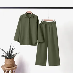 Olive green women's two-piece set with lapel shirt and wide-leg pants on rack