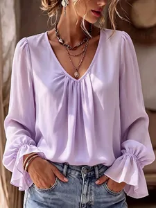 Detail of elegant lavender V-neck blouse with pleated ruffles on cuffs