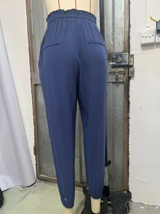 Rear view of blue high-waisted jogger pants featuring an elastic waistband and back pockets
