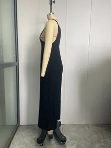 Detailed side view of a minimalist solid black casual jumpsuit for women on a mannequin