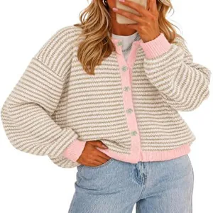Detailed view of women's striped knit cardigan with pink contrast ribbed trim and buttons
