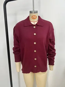 Detailed shot of womens solid color knit cardigan sweater with large wooden buttons.
