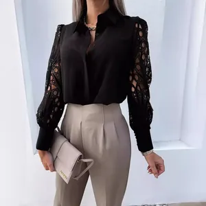 Elegant black long-sleeved blouse with intricate lace cutout sleeves and collar