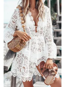 Detail of white floral lace crochet bikini cover-up with sexy V-neck and long sleeves