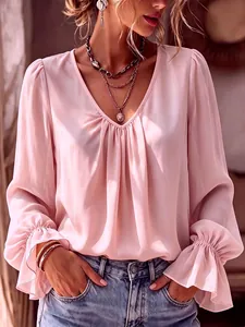 Close-up detail showing the pleated V-neck and ruffled cuffs of a pink women shirt