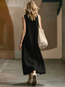 Rear view detail of a minimalist black sleeveless maxi dress for spring and summer