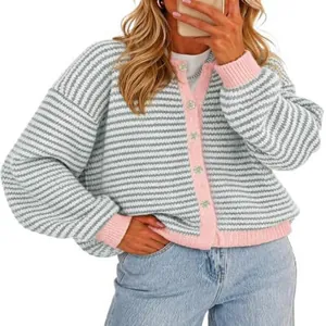 Detailed view of women striped knitted cardigan with pink trim and loose fit design