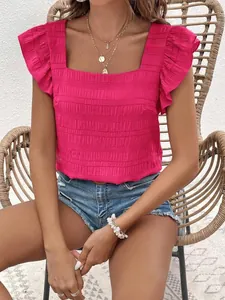 Detailed view of pink square neck blouse with ruffled sleeves and smocked texture