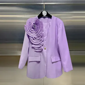 Close-up of elegant purple blazer featuring a large 3D pleated floral decoration