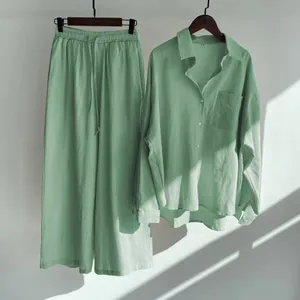 Detailed view of women's mint green cotton linen set under natural light and shadow