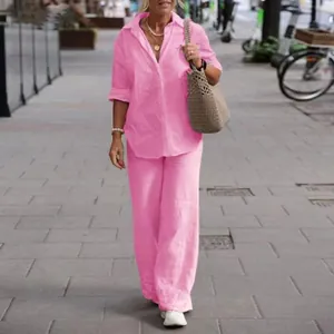 Full view of women's vibrant pink long-sleeved shirt and matching wide-leg trousers set