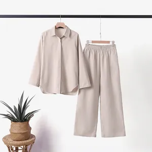 Elegant beige women's two-piece set with long-sleeved shirt and wide-leg trousers