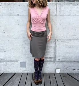 Close-up of pink cross V-neck tank top and grey ruched skirt outfit street style set