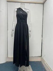 Close-up detail of a black one-shoulder maxi dress featuring a high waist and side slit