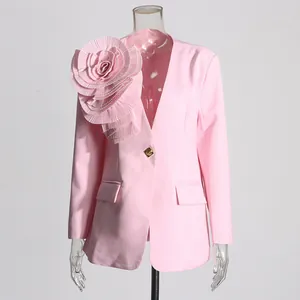 Detail of a light pink blazer featuring a large pleated 3D flower on the shoulder
