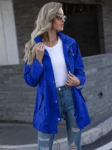 Royal blue women's mid-length hooded raincoat jacket in an outdoor urban setting