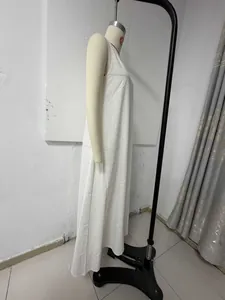 Side profile of a white sleeveless Bohemian loose vacation maxi dress on a mannequin