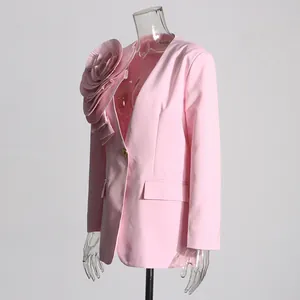 Side detail of pink blazer featuring large 3D pleated fabric flower decoration