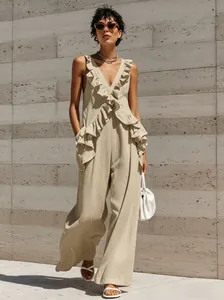 Detailed view of the elegant ruffled V-neck and cotton linen fabric of the beige jumpsuit