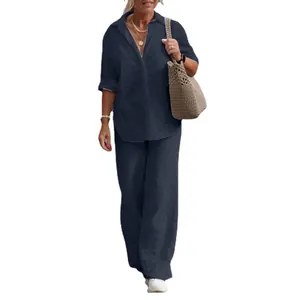 Elegant navy blue two-piece set with long-sleeved shirt and wide-leg trousers.