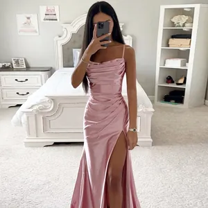 Detailed look at the pink ruched satin slit evening dress in a bedroom mirror selfie.