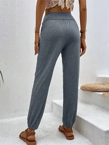 Rear view of women's grey high waisted joggers showing loose fit and cuffed ankles