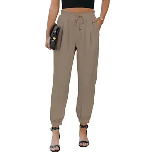 Front view of stylish women's high-waisted khaki drawstring cuffed joggers on model
