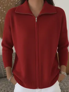 Casual red knit cardigan with a zipper and collar for women in a cozy indoor setting.
