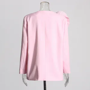 Back view of pink slim-fit blazer with pleated 3D flower shoulder detail