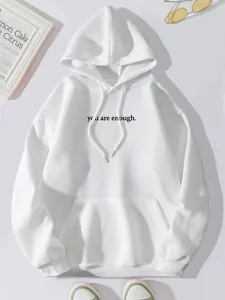 Detailed macro view of the 'you are enough' print on a soft white fleece-lined hoodie